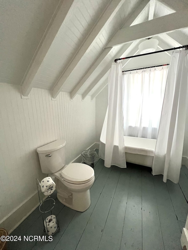 bathroom featuring wood walls, wood-type flooring, lofted ceiling with beams, toilet, and a shower with shower curtain