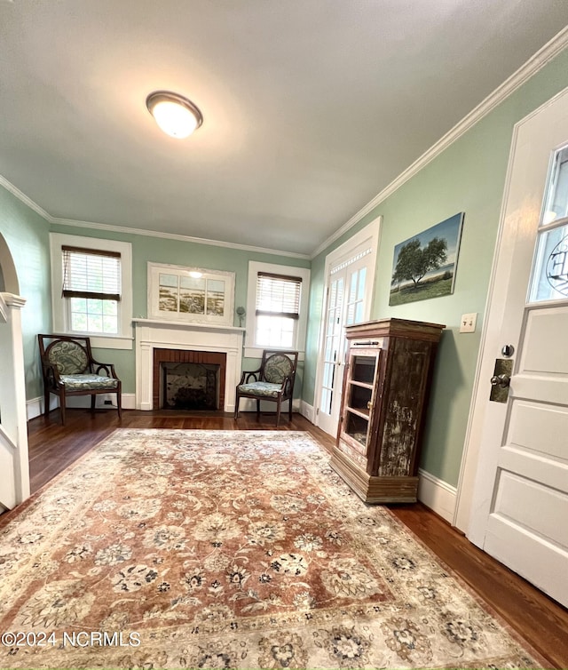 living room featuring ornamental molding, plenty of natural light, and dark hardwood / wood-style flooring