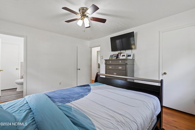 bedroom featuring dark wood-type flooring, ceiling fan, and ensuite bathroom