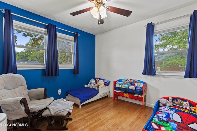 bedroom featuring hardwood / wood-style floors and ceiling fan