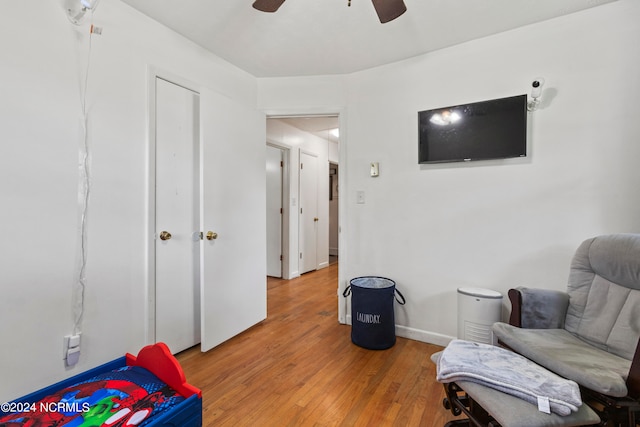 living area with ceiling fan and light wood-type flooring