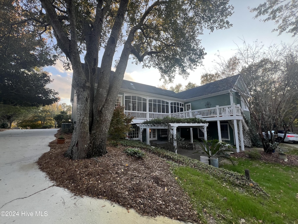 view of front of house featuring a sunroom and a patio area