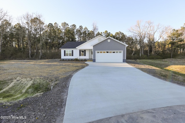 ranch-style home featuring driveway and an attached garage