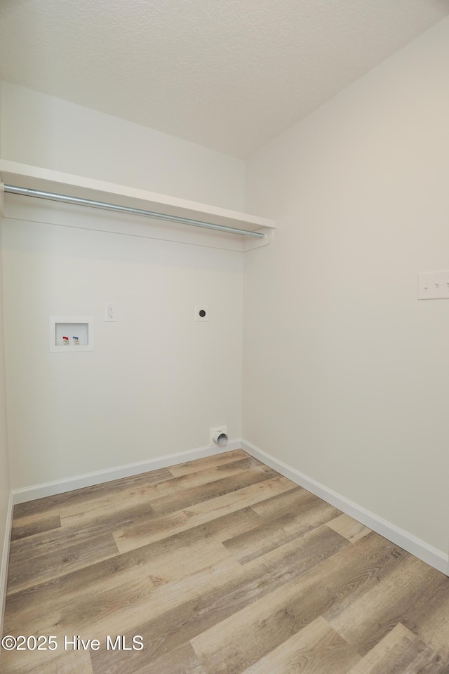 clothes washing area with laundry area, wood finished floors, hookup for a washing machine, and electric dryer hookup