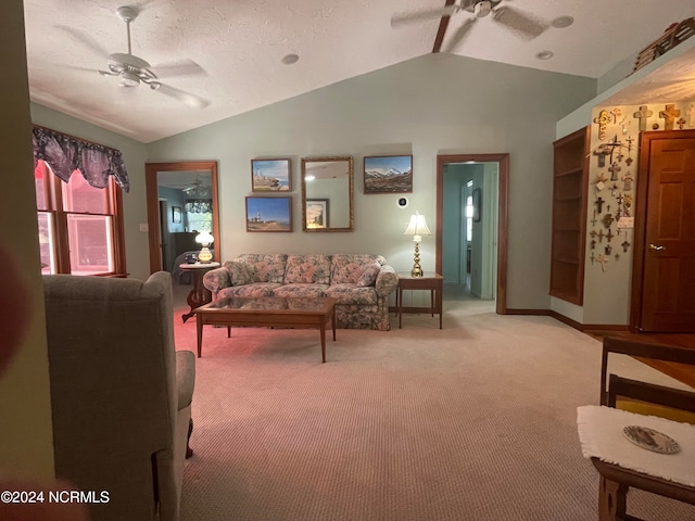 living room with vaulted ceiling, ceiling fan, and light colored carpet