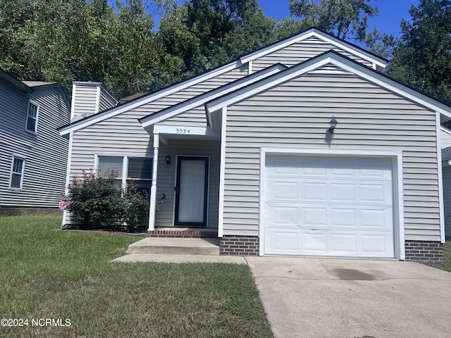 view of front facade with a front yard and a garage