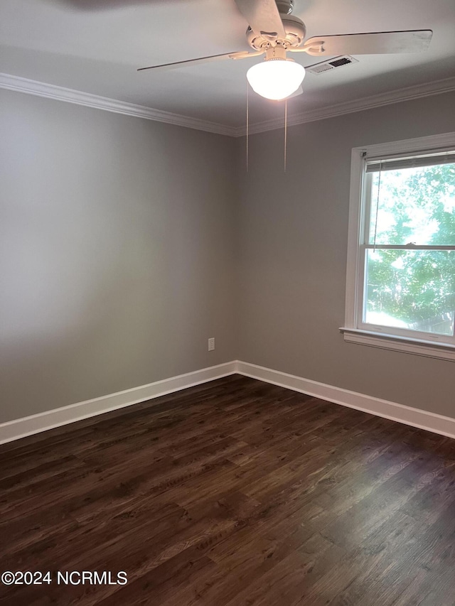 empty room featuring ceiling fan, crown molding, and dark hardwood / wood-style flooring