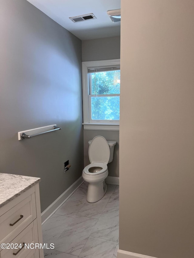 bathroom featuring vanity and toilet