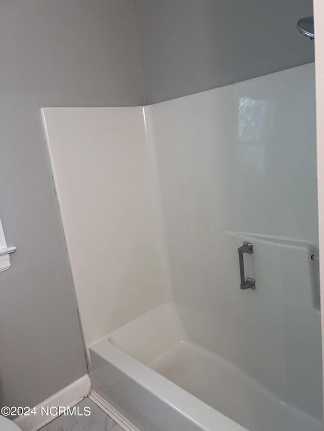 bathroom featuring plus walk in shower and tile patterned flooring