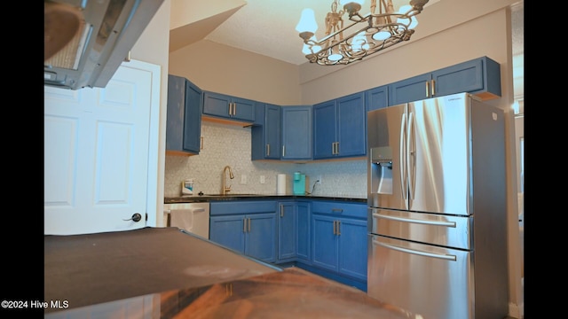 kitchen with blue cabinetry, a notable chandelier, sink, and stainless steel appliances