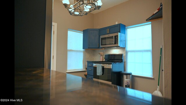 kitchen with plenty of natural light, tasteful backsplash, and black electric range