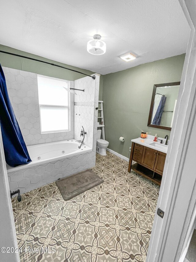 full bathroom with shower / bath combo, tile patterned flooring, a textured ceiling, toilet, and vanity