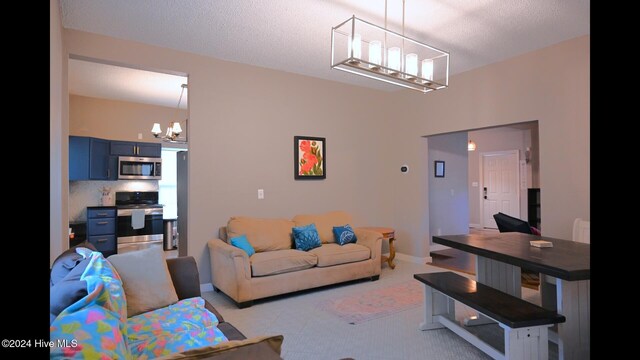 living room with light colored carpet, a textured ceiling, and an inviting chandelier