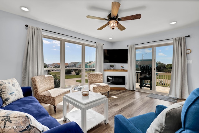 living room with a healthy amount of sunlight, hardwood / wood-style floors, and ceiling fan