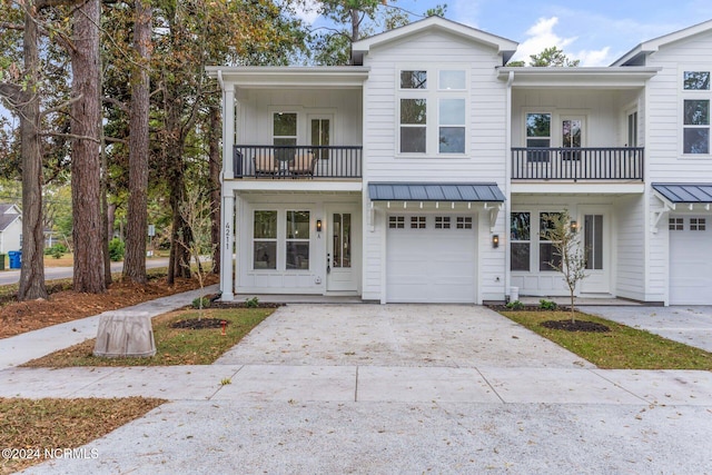 view of property featuring a balcony and a garage