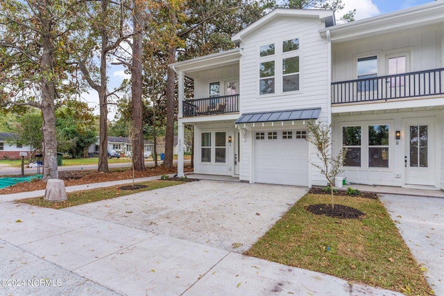 townhome / multi-family property featuring a balcony and a garage