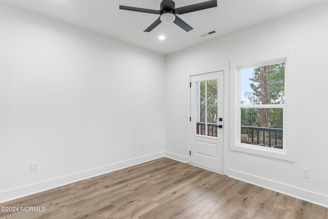 empty room with hardwood / wood-style flooring and ceiling fan