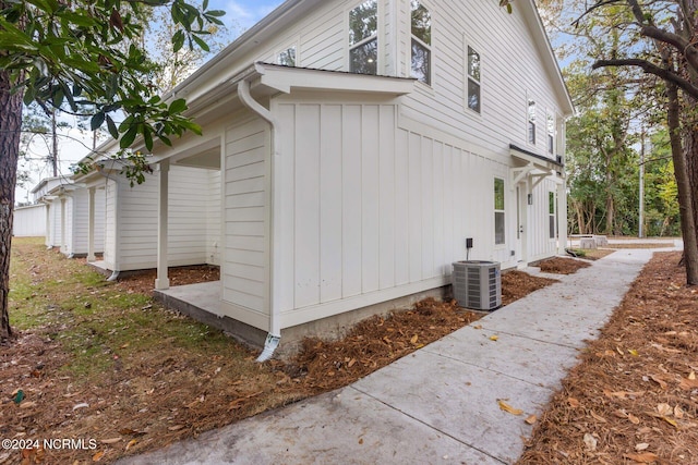 view of side of home with central air condition unit