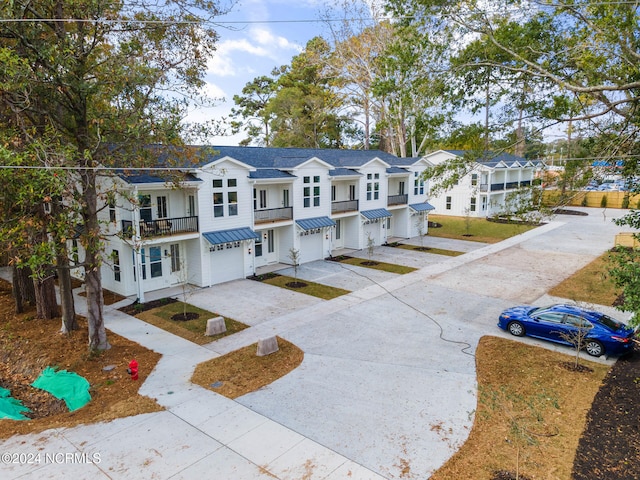 view of front facade featuring a balcony and a garage