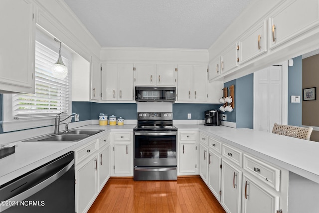 kitchen with light hardwood / wood-style floors, sink, ornamental molding, white cabinets, and appliances with stainless steel finishes