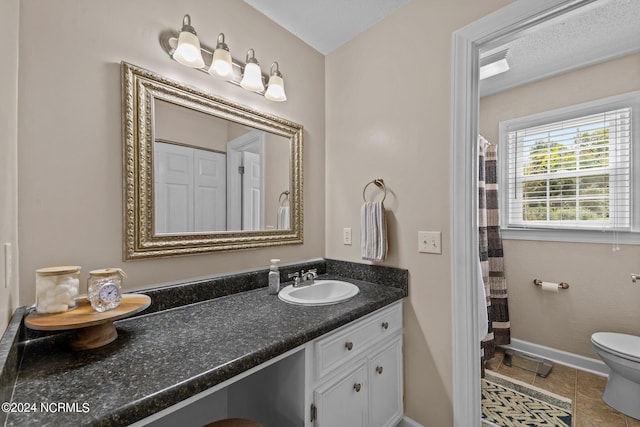 bathroom featuring vanity, a textured ceiling, tile patterned floors, toilet, and a shower with shower curtain