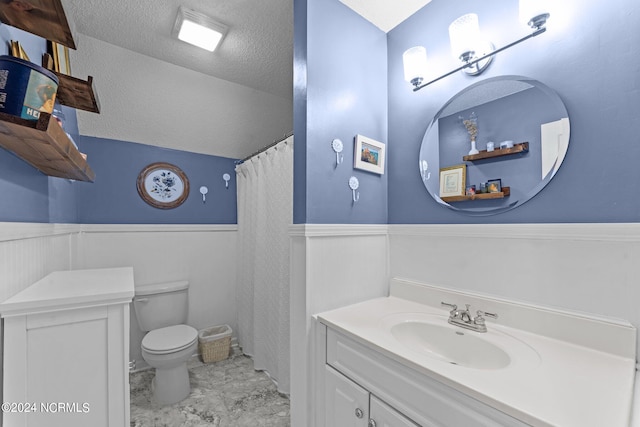 bathroom with toilet, vaulted ceiling, a shower with shower curtain, vanity, and a textured ceiling