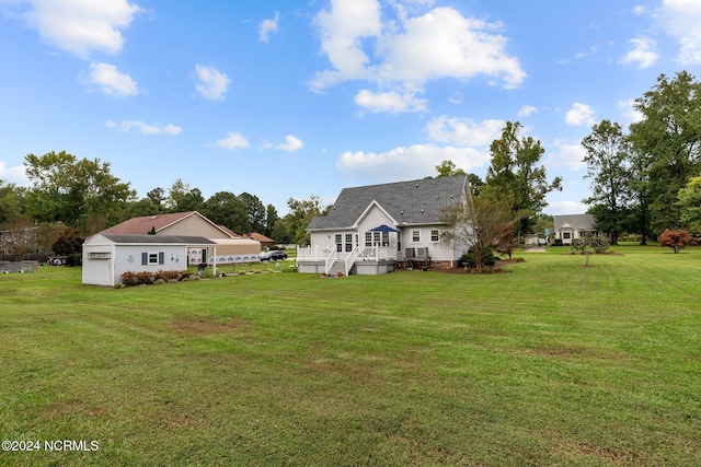 back of property with a yard and a wooden deck