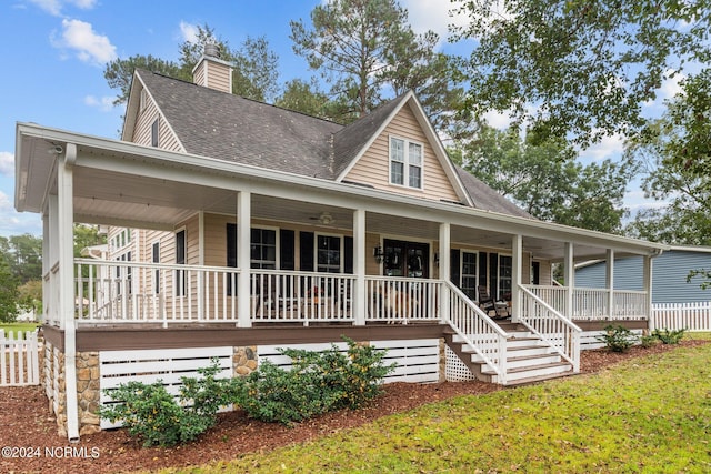 306 4th St, Pollocksville, NC 28573 - country-style home featuring covered porch, a shingled roof, fence, and a chimney