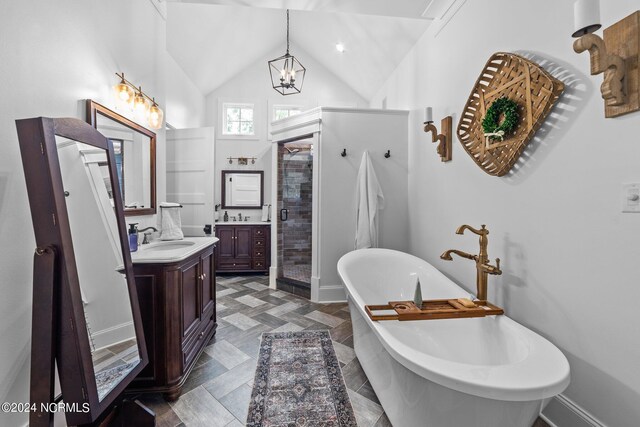 306 4th St, Pollocksville, NC 28573 - full bath featuring a soaking tub, vanity, lofted ceiling, a stall shower, and a notable chandelier