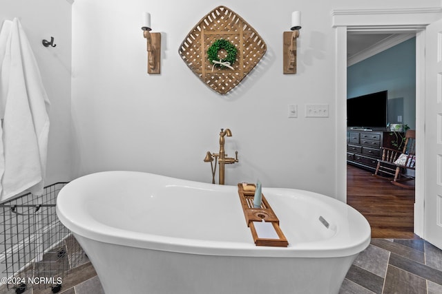 306 4th St, Pollocksville, NC 28573 - bathroom with a freestanding tub, crown molding, and stone finish flooring