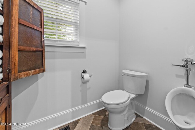306 4th St, Pollocksville, NC 28573 - bathroom featuring baseboards and toilet