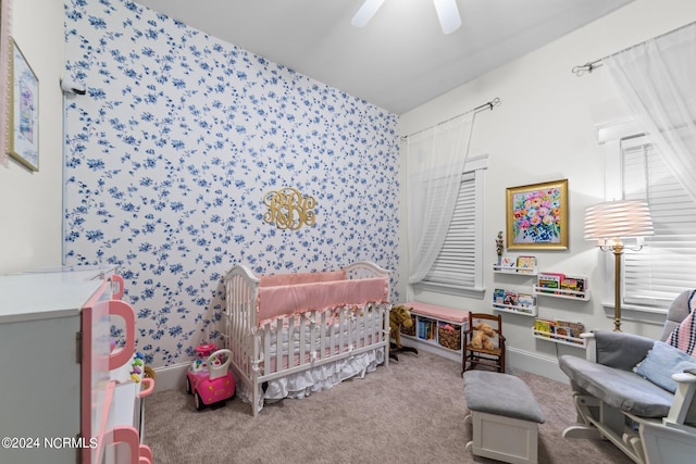 306 4th St, Pollocksville, NC 28573 - bedroom featuring baseboards, a nursery area, wallpapered walls, carpet floors, and a ceiling fan