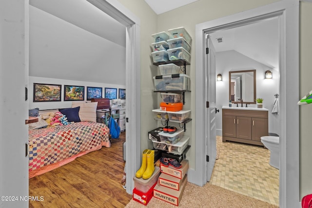 306 4th St, Pollocksville, NC 28573 - bedroom with a sink, ensuite bath, visible vents, and vaulted ceiling