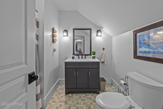 306 4th St, Pollocksville, NC 28573 - bathroom with baseboards, toilet, vaulted ceiling, and vanity