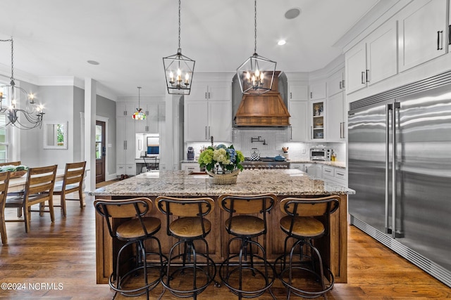 306 4th St, Pollocksville, NC 28573 - kitchen with decorative backsplash, ornamental molding, stainless steel built in fridge, and a notable chandelier