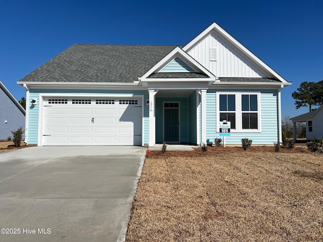 view of front of house featuring a garage and a front lawn