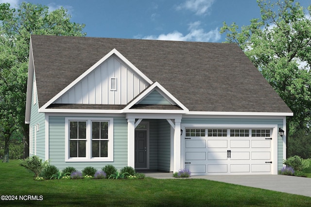 view of front of home with a garage and a front lawn