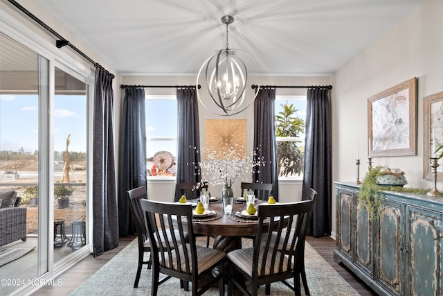 dining space with light hardwood / wood-style floors and a notable chandelier