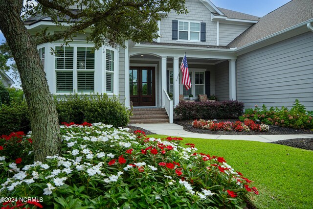 view of front of property with a garage and a front lawn