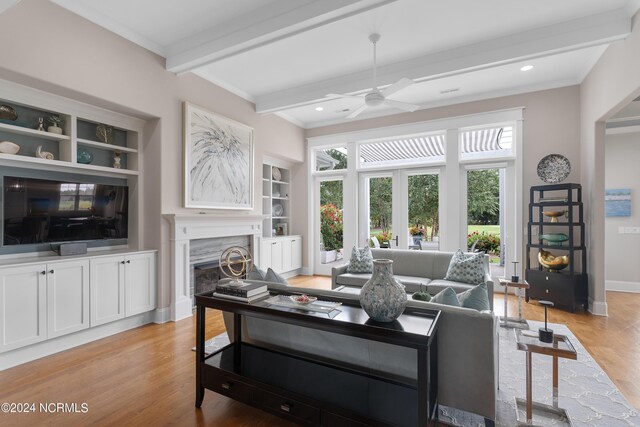 living area featuring wine cooler, wood finished floors, beamed ceiling, and a high end fireplace