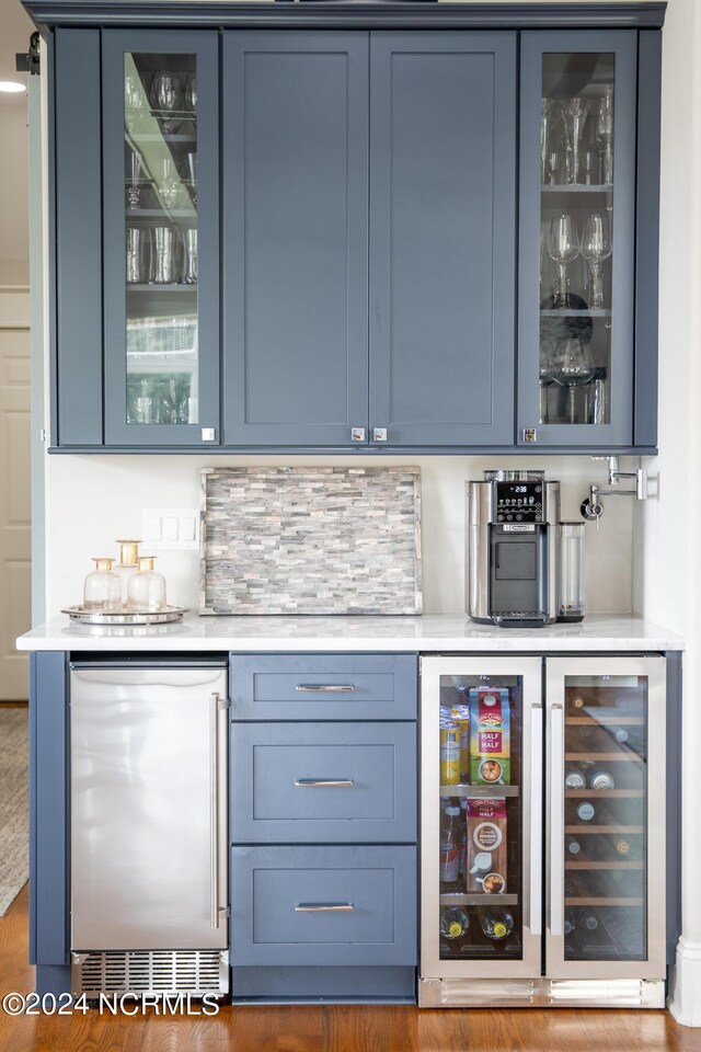 kitchen featuring stainless steel appliances, glass insert cabinets, a kitchen breakfast bar, and a large island