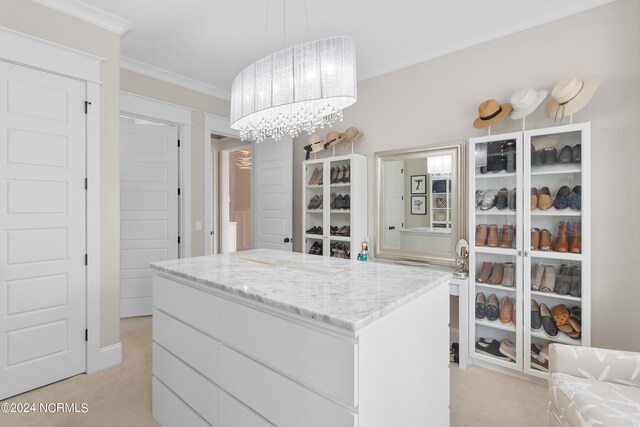 walk in closet featuring a notable chandelier, visible vents, and light colored carpet