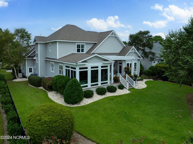 drone / aerial view with view of golf course and a water view