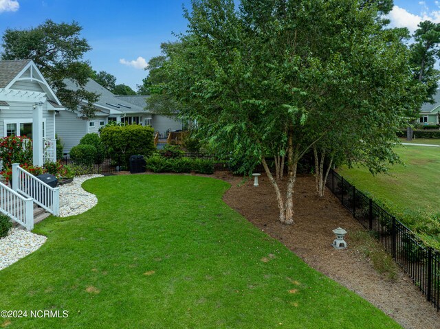 rear view of property with a sunroom, a pergola, and a yard