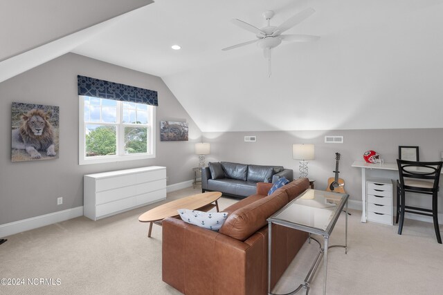 living room featuring light carpet, vaulted ceiling, and plenty of natural light