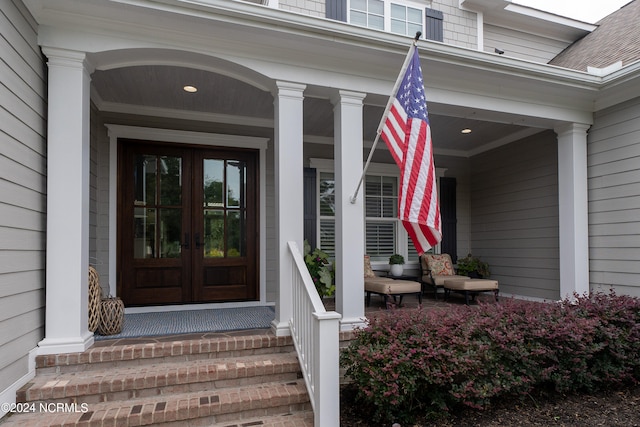 property entrance with roof with shingles and french doors