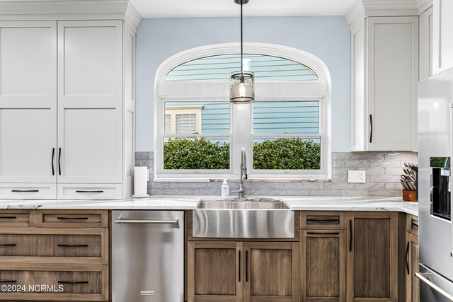 kitchen with stainless steel fridge with ice dispenser, sink, white cabinetry, hanging light fixtures, and backsplash