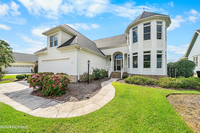 view of front of property featuring a garage and a front yard