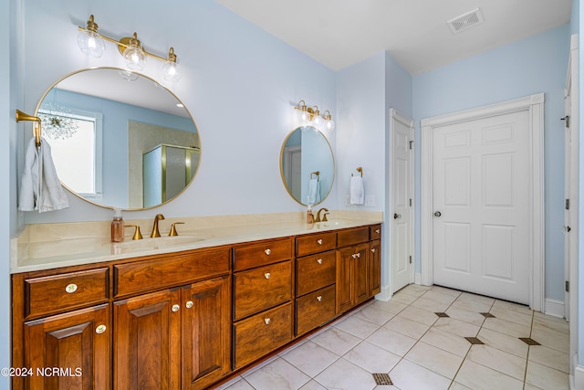 bathroom with tile patterned flooring, vanity, and a shower with shower door