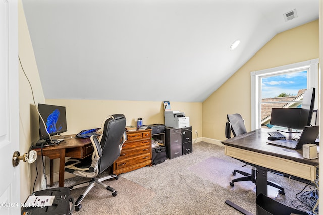 carpeted office space with vaulted ceiling